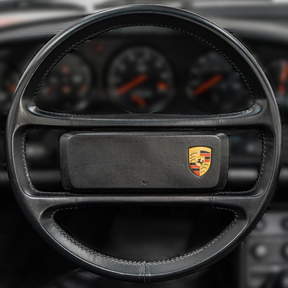 Leather steering wheel with offset Porsche crest